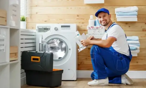 Technician performing washing machine repair in Dubai.